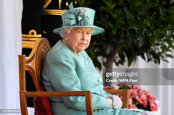Queen Elizabeth II attends a ceremony to mark her official birthday at Windsor Castle on June 13, 2020 in Windsor, England. The Queen celebrates her...