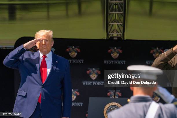 President Donald Trump salutes cadets at the beginning of the commencement ceremony on June 13, 2020 in West Point, New York. The graduating cadets...