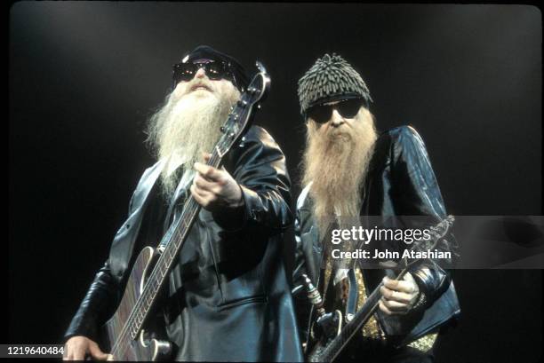 Musicians Dusty Hill and Billy Gibbons of the rock band ZZ Top are shown performing on stage during a "live" appearance on July 12,1993.