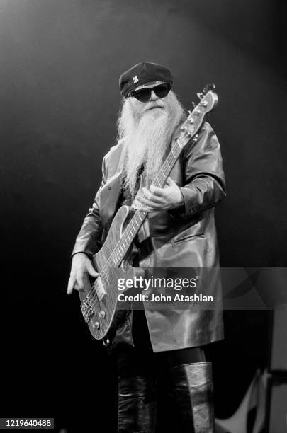 Bassist and singer Dusty Hill of the rock band ZZ Top is shown performing on stage during a "live" appearance on July 12,1993.