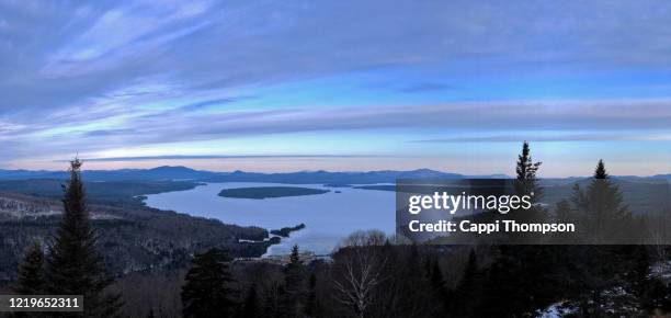 lake mooselookmeguntic at sunrise during springtime in rangeley, maine usa - mooselookmeguntic lake stockfoto's en -beelden