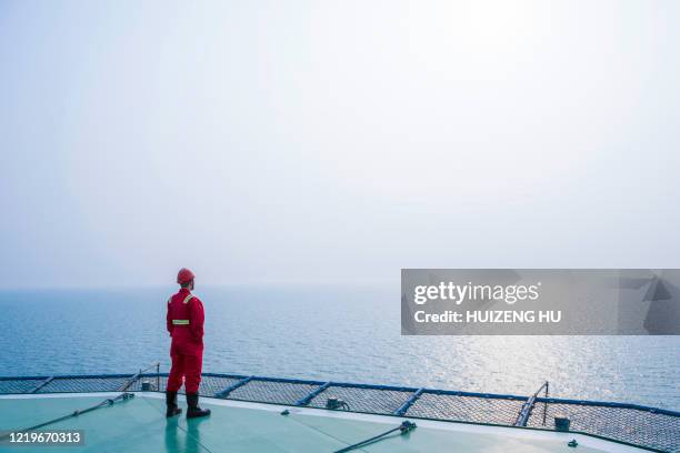 young male standing on the helicopter deck - offshore drilling stock pictures, royalty-free photos & images