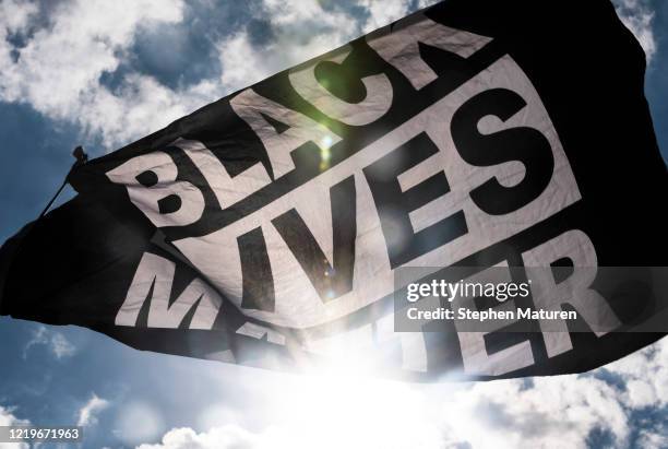 Black Lives Matter flag waves during a demonstration outside the First Police Precinct Station on June 13, 2020 in Minneapolis, Minnesota. Protests...