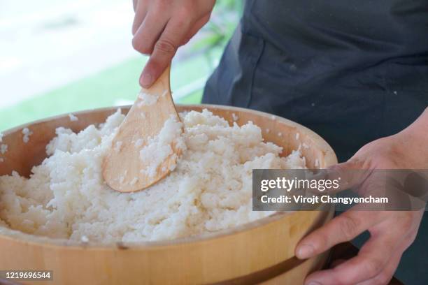 man making sushi rice in wooden bowl with ingredients - bath salt ストックフォトと画像