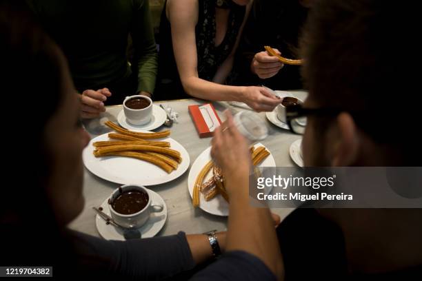 traditional churros for breakfast in spain - chocolate con churros stock pictures, royalty-free photos & images