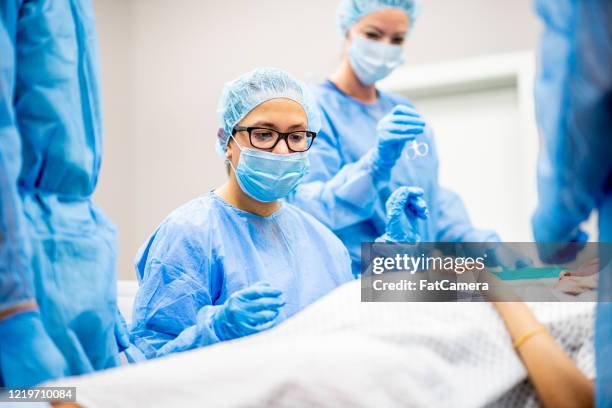 surgeons in a hospital - caesarean section stock pictures, royalty-free photos & images