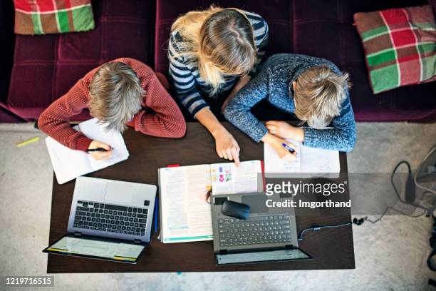 mother homeschooling her children - remote location stock pictures, royalty-free photos & images