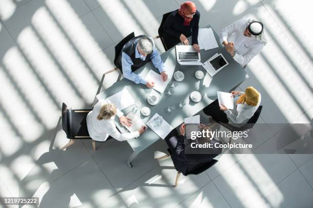 multiethnic group of business people having a meeting. - arab businessman stock pictures, royalty-free photos & images