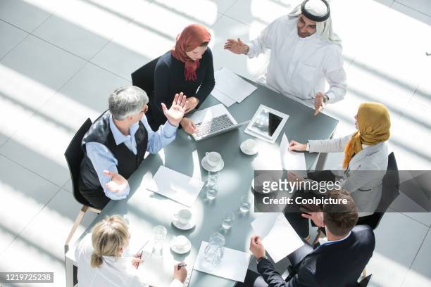 multiethnic group of business people having a meeting. - old saudi man stock pictures, royalty-free photos & images