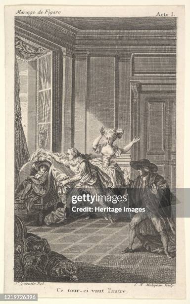 Man curled up in a chair looks toward another man who approaches him from the left in an interior setting, a woman and a man stand nearby with their...