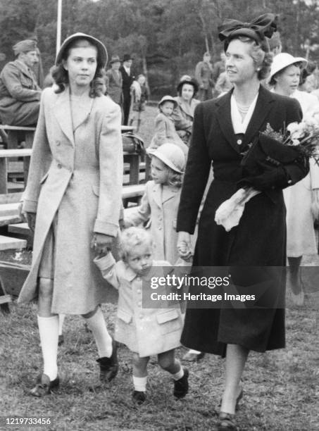 Crown Prince Carl Gustav with mother Sibylla and big sister Margaretha, Stockholm, Sweden, 1947. In the background, child nurse Nenne Bjornberg....