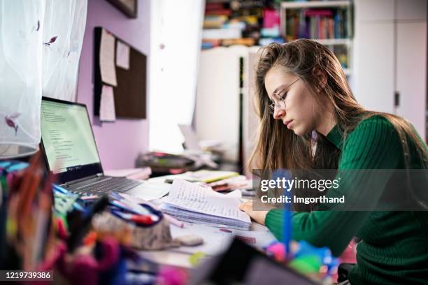 teenage girl doing homework in her room. - secondary school covid stock pictures, royalty-free photos & images