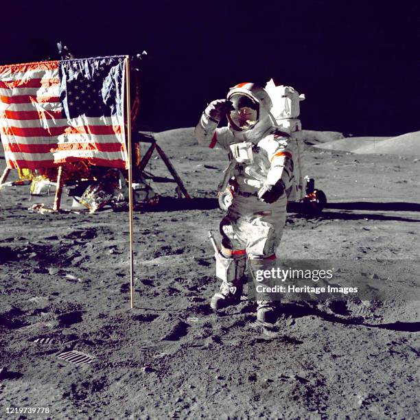 Apollo 17 The Last Man on the Moon: Eugene Cernan poses by the American flag in his A7L spacesuit, December 1972. Artist NASA.