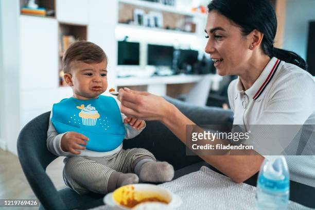 trying to feed a baby boy - picky eater stock pictures, royalty-free photos & images