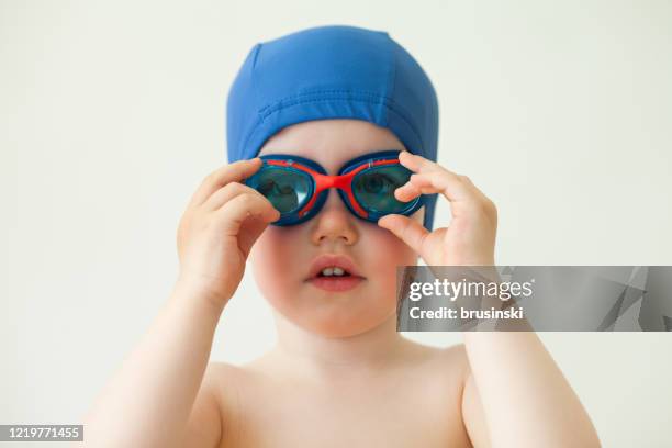 verticale d’un bébé de 2 ans sur un fond blanc - lunettes de plongée photos et images de collection
