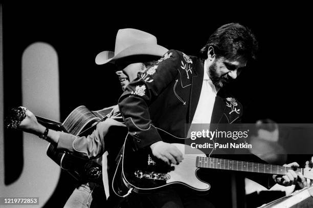 American Country musician Dwight Yoakam and Pete Anderson perform onstage at the Chicago Theater, Chicago, Illinois, August 5, 1988.