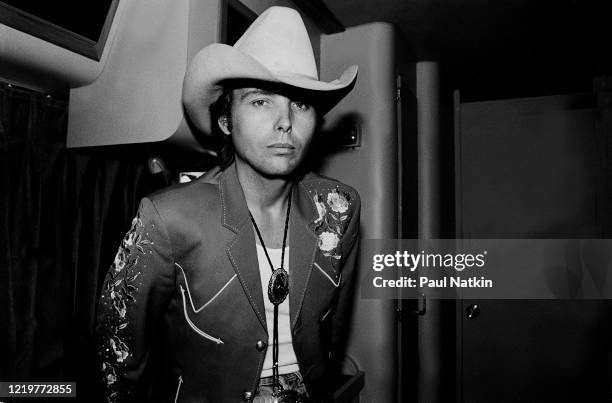 Portrait of American Country musician Dwight Yoakam as he poses backstage at the Chicago Theater, Chicago, Illinois, August 5, 1988.