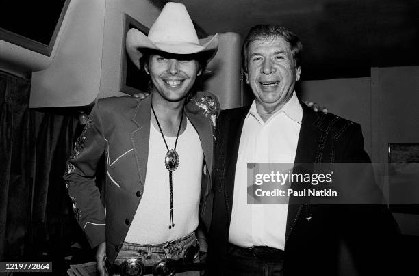 Portrait of American Country musicians Dwight Yoakam and Buck Owens as they pose backstage at the Chicago Theater, Chicago, Illinois, August 5, 1988.