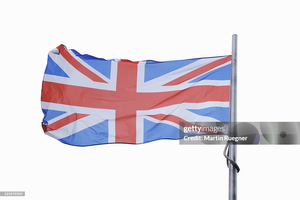 The British Union Jack flag flaps in a stiff wind.