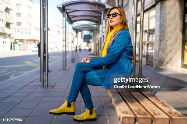 駅でバスを待っている女性 - bus shelter ストックフォトと画像