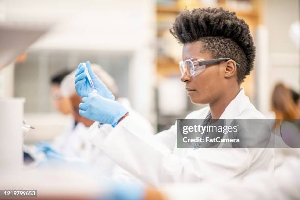 scientist look for a cure - medical lab technician stock pictures, royalty-free photos & images