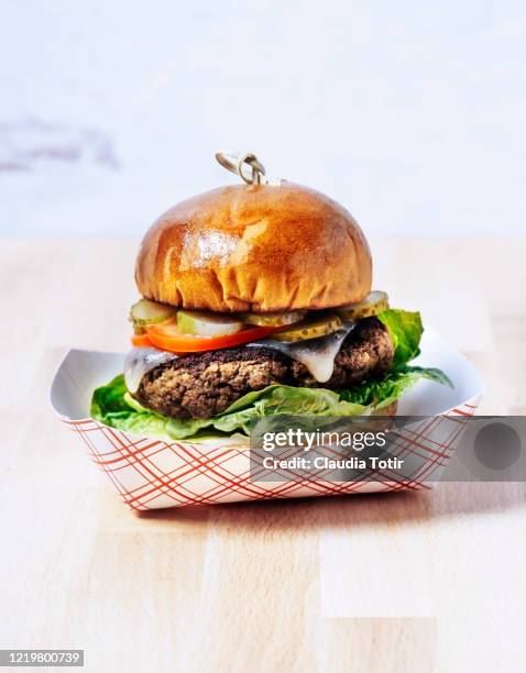 burger on paper tray on wooden background - pickle tray stock pictures, royalty-free photos & images