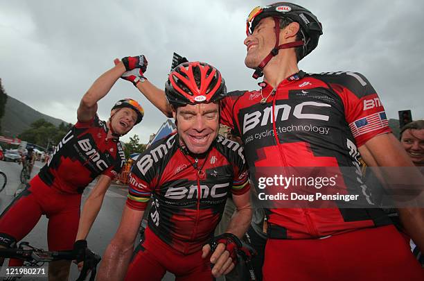 George Hincapie of the USA riding for BMC Racing celebrates his victory with teammate Cadel Evans of Australia and Jeff Louder of the USA in stage...