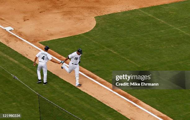 Jose Lopez of the Florida Marlins rounds third after hitting a two run home run during game one of a doubleheader against the Cincinnati Reds at Sun...