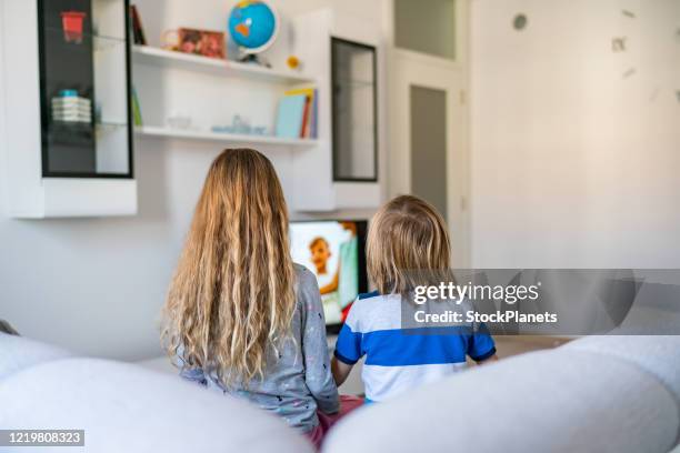 rear view of kids watching tv - boy at television stock pictures, royalty-free photos & images