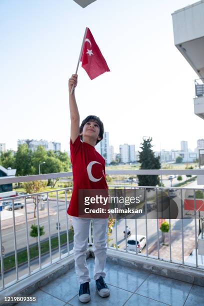 little boy holding turkish flag for celebration of national sovereignty and children’s day - national holiday stock pictures, royalty-free photos & images
