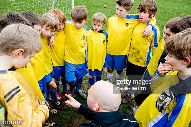 boys with football coach, high angle - amici calcio foto e immagini stock