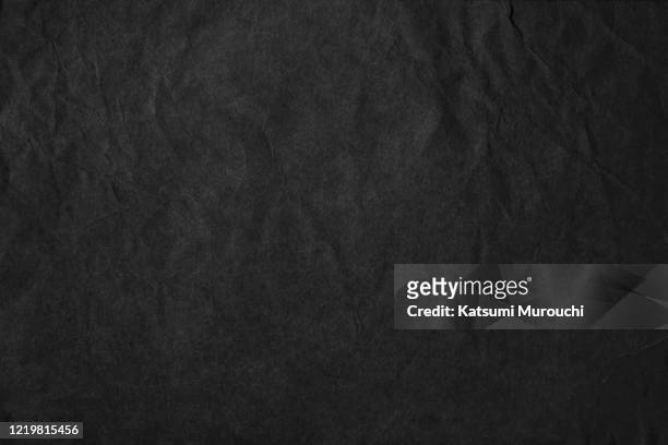 wrinkled black craft paper texture background - black paper stock-fotos und bilder