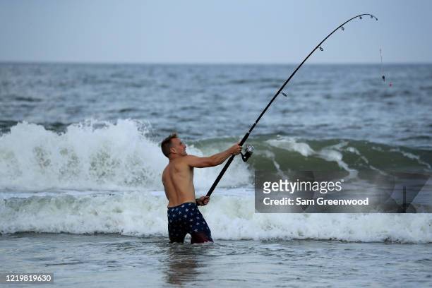 Person is seen fishing at the beach on April 19, 2020 in Jacksonville Beach, Florida. Jacksonville Mayor Lenny Curry announced Thursday that Duval...