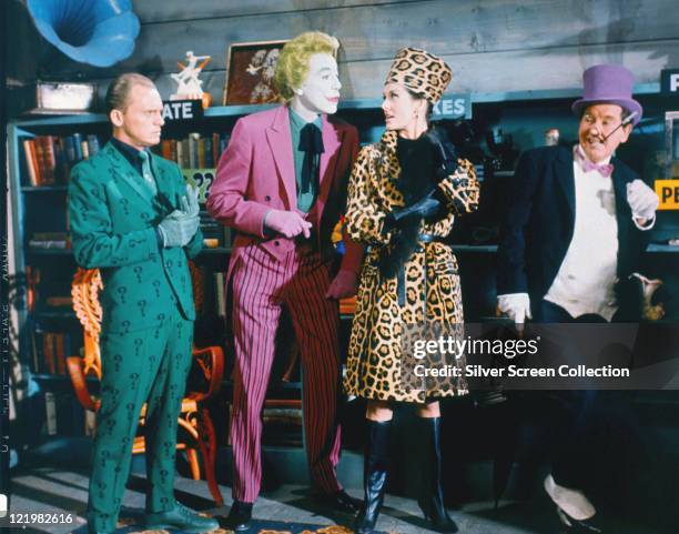 Frank Gorshin , US actor and comedian, Cesar Romero , Lee Meriwether, US actress, and Burgess Meredith , US actor, all in costume, in a publicity...