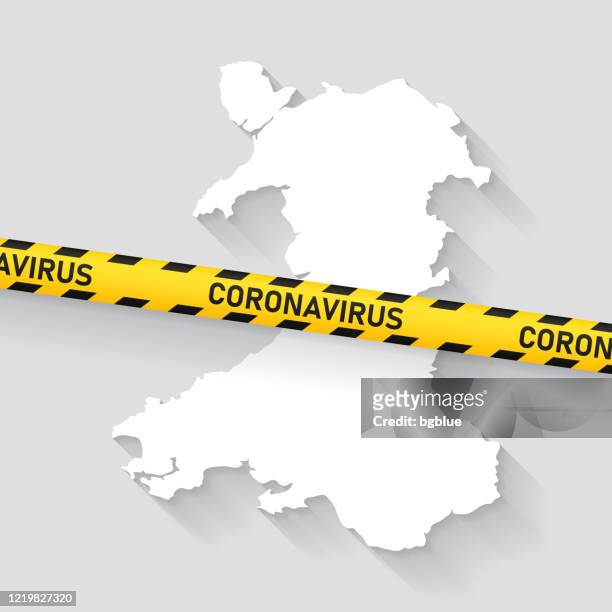wales map with coronavirus caution tape. covid-19 outbreak - cardiff stock illustrations