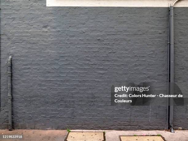 london brick house facade with water pipe and electrical installation - painted brick house stock pictures, royalty-free photos & images