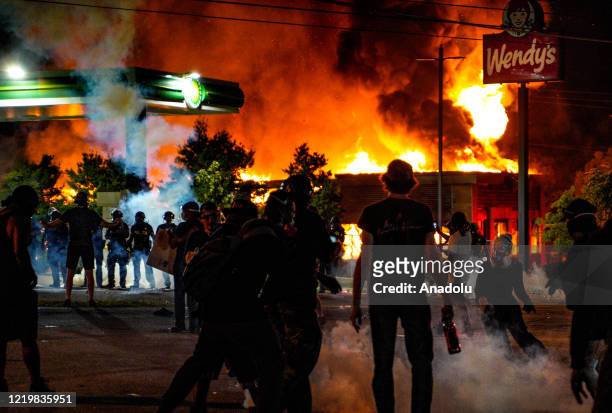 Demonstrators set on fire a restaurant during the protest after an Atlanta police officer shot and killed Rayshard Brooks at a Wendy's fast food...