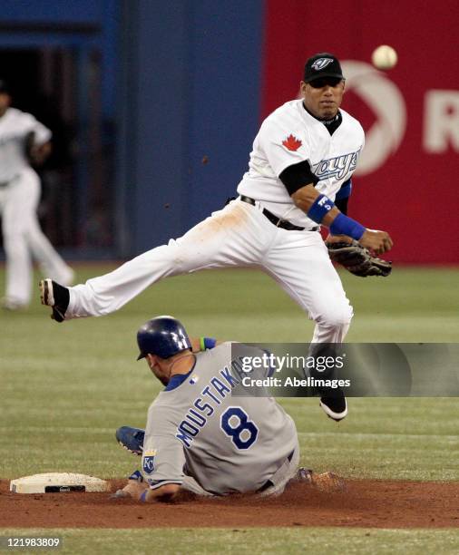 Yunel Escobar of the Toronto Blue Jays makes the double play on Mike Moustakas of the Kansas City Royals during MLB action at Rogers Centre August...