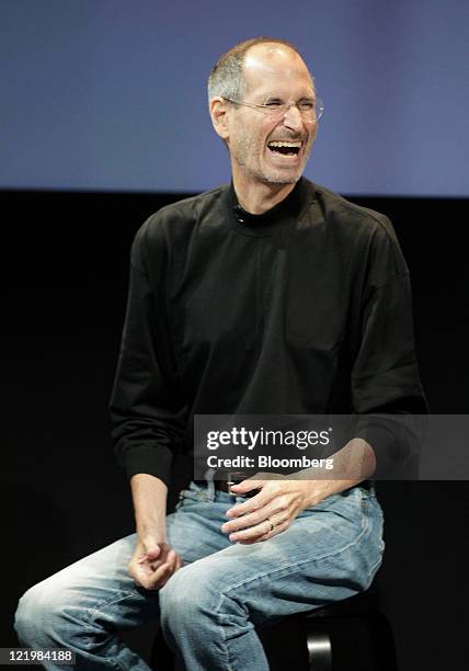 Steve Jobs, chief executive officer of Apple Inc., laughs as he talks about the Apple iPhone 4 at a news conference in Cupertino, California, U.S.,...