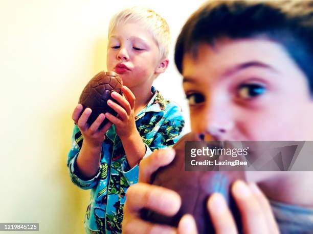children eating easter eggs - easter new zealand stock pictures, royalty-free photos & images