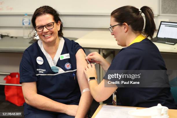 Registered nurse Heather Hoppe receives a BCG injection in the trial clinic at Sir Charles Gairdner hospital on April 20, 2020 in Perth, Australia....