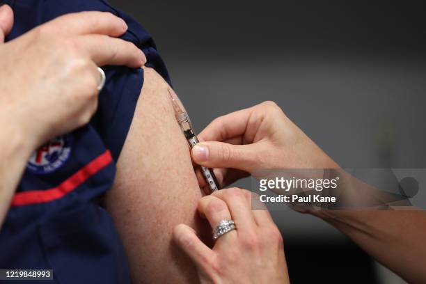 Clinical nurse Wendy Dickinson receives a BCG injection in the trial clinic at Sir Charles Gairdner hospital on April 20, 2020 in Perth, Australia....