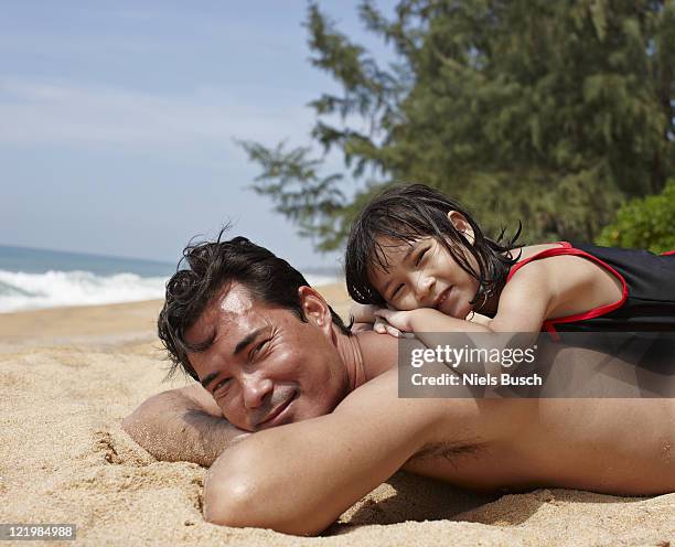 ilustrações de stock, clip art, desenhos animados e ícones de father and daughter relaxing on beach - asian family