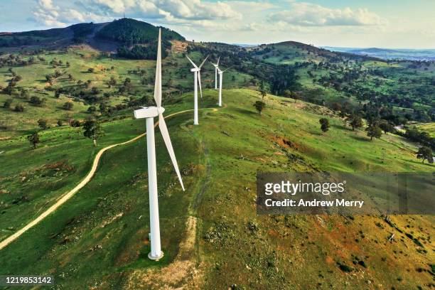 wind turbine, wind farm in green field with mountains - wind farm australia fotografías e imágenes de stock