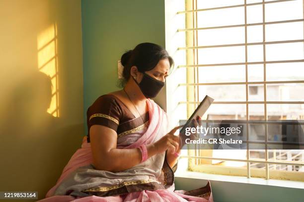 woman in quarantine, staying home for safety during coronavirus pandemic - staying indoors stock pictures, royalty-free photos & images