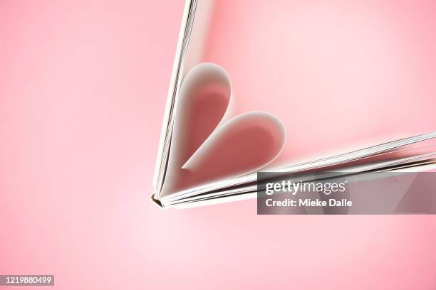 open boek in de vorm van een hartje - broken heart stock pictures, royalty-free photos & images