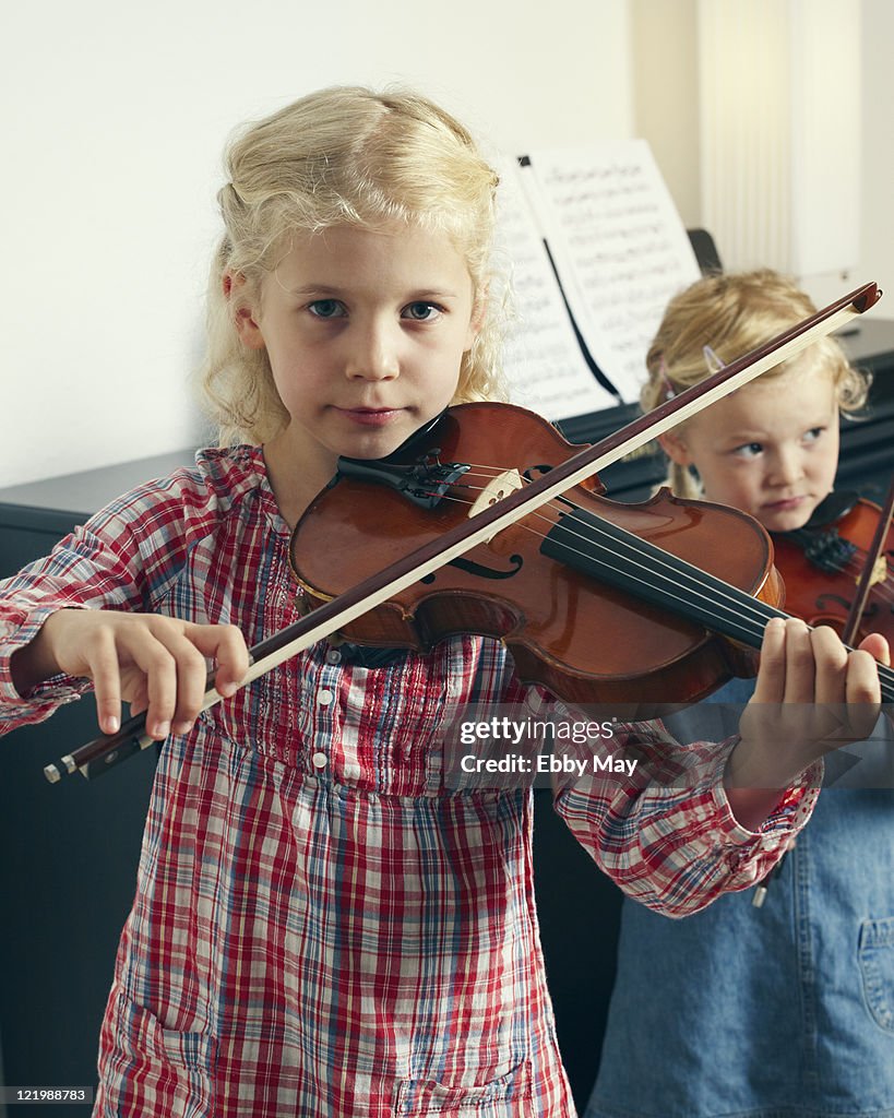 Two girls playing violin