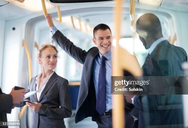 businesspeople in train - man riding bus fotografías e imágenes de stock