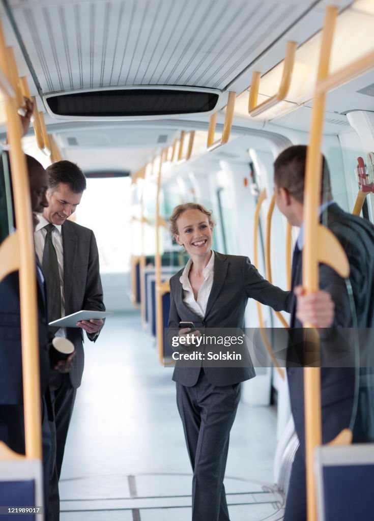 Businesspeople standing in train