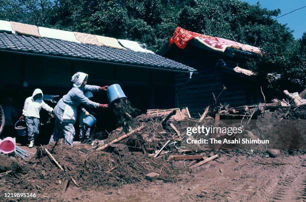 Local residents clear mud after a landslide on September 11, 1971 in Owase, Mie, Japan.